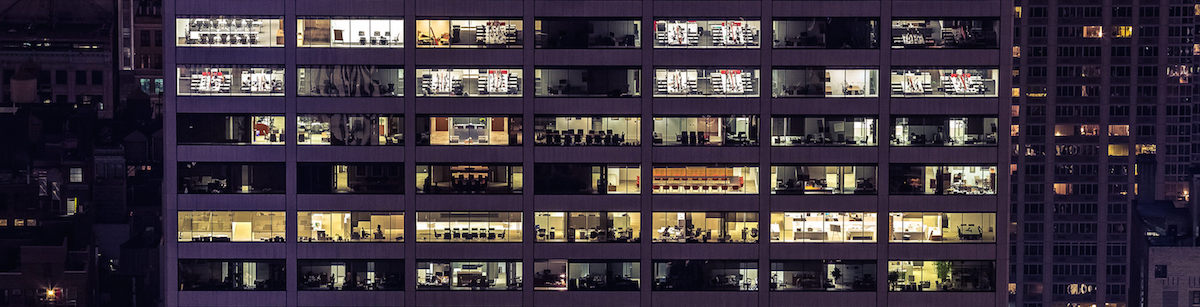 Windows of a tall building at night