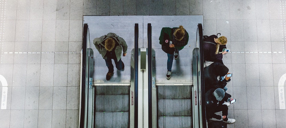 Watching as people ride escalators