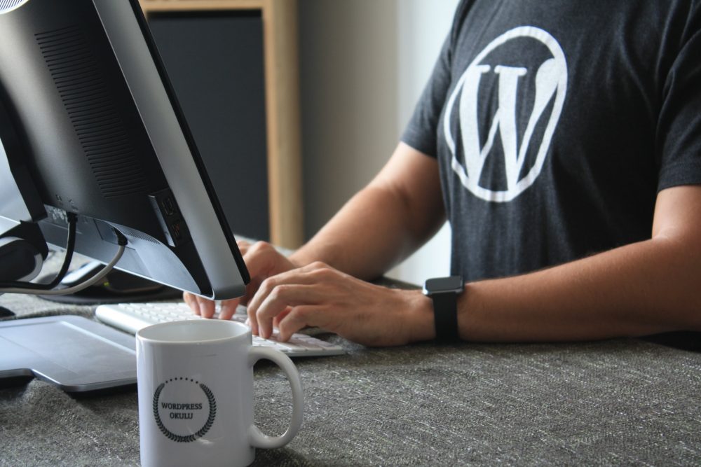 man in black tshirt on laptop improve customer experience