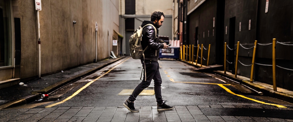 A man in an alley on his phone