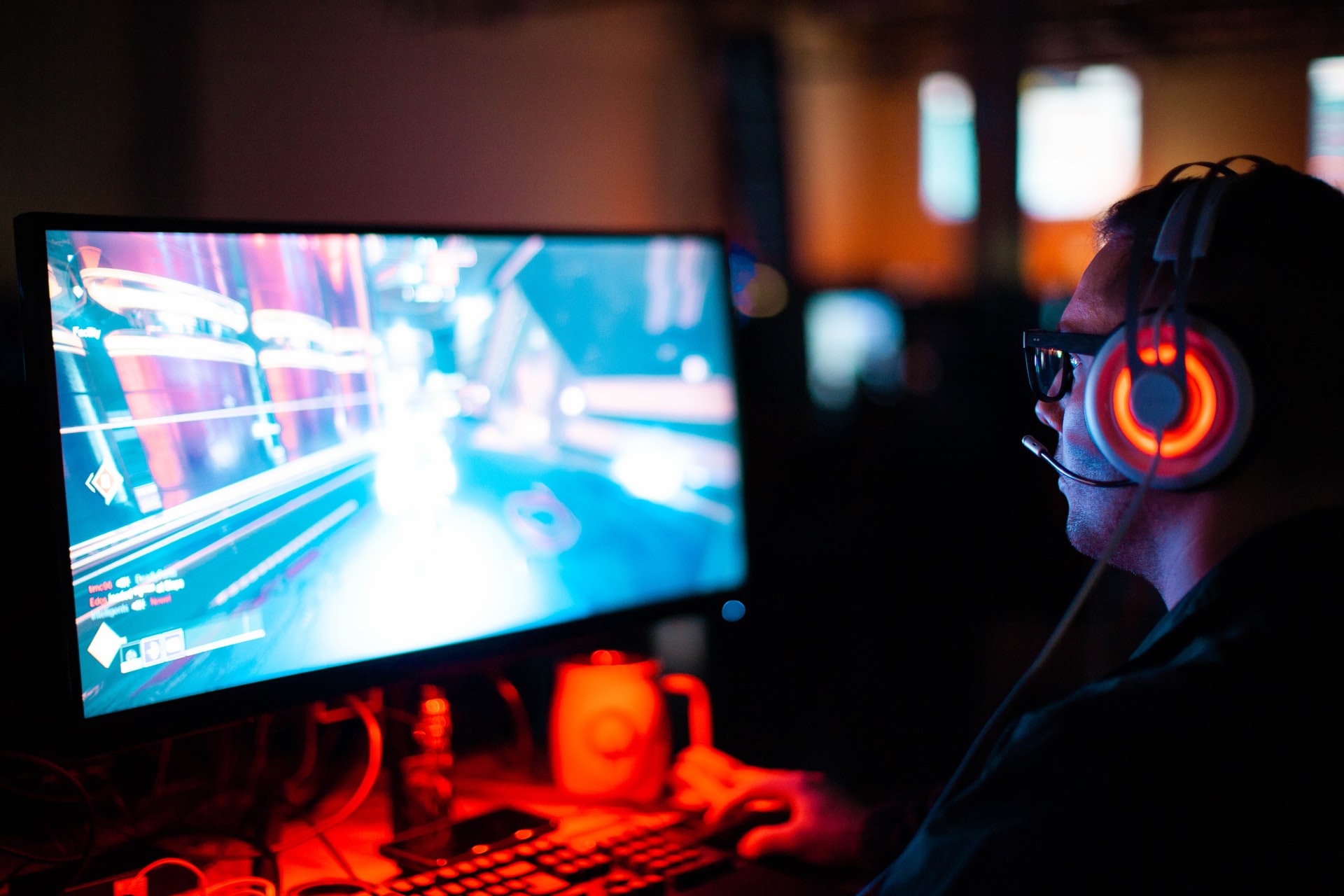 gamer with headset playing on computer