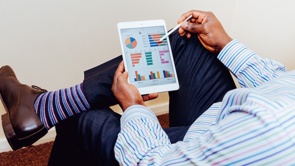 A businessman studies data on his tablet