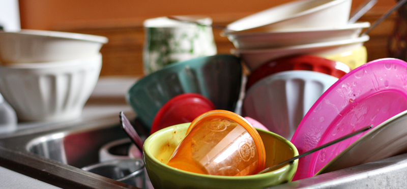 A pile of dirty dishes in a sink