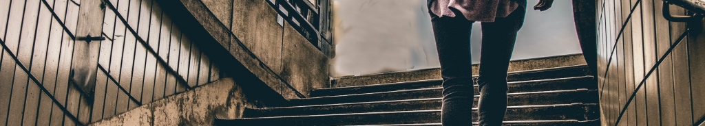 Woman escaping up a flight of stairs