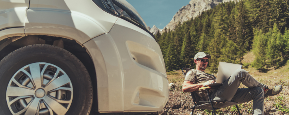 remote usability testing man sitting outside car in foresty area on laptop